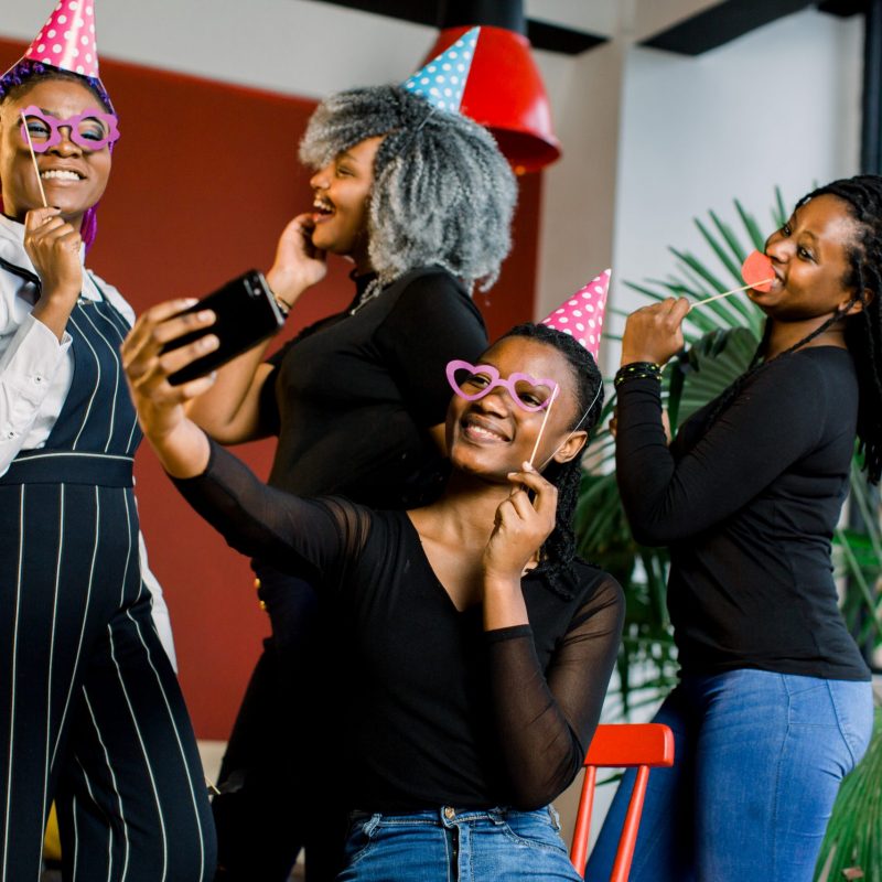 African American girls celebrate their friend's birthday, happy, laugh and doing selfi.