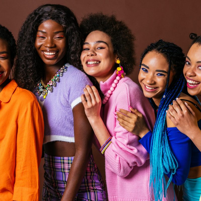 Beauty portrait of beautiful black women wearing colorful stylish clothes - Pretty african young women posing in studio, concepts about beauty, cosmetology and diversity